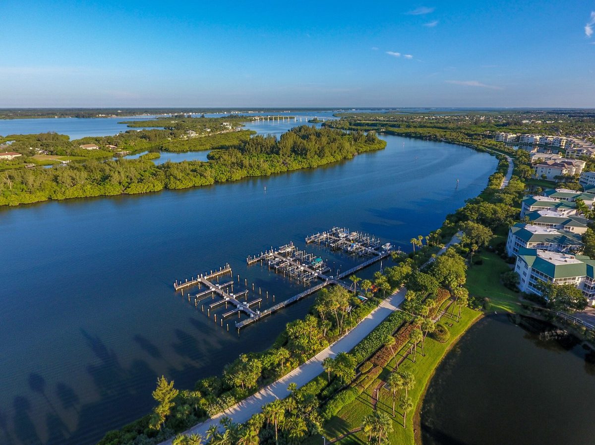 Sea Oaks Vero Beach deep-water marina Indian River Lagoon aerial view — achievement destination waterfront community barrier island year-round water access Florida luxury real estate