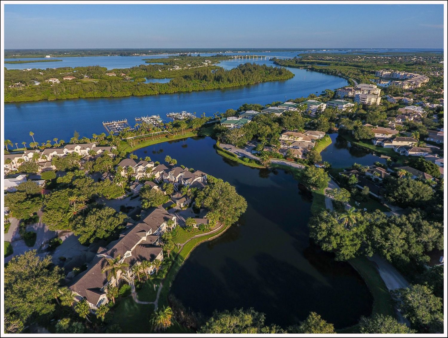 Aerial view of a gated waterfront community along the Indian River Lagoon in Vero Beach, Florida, with private marina and Intracoastal access