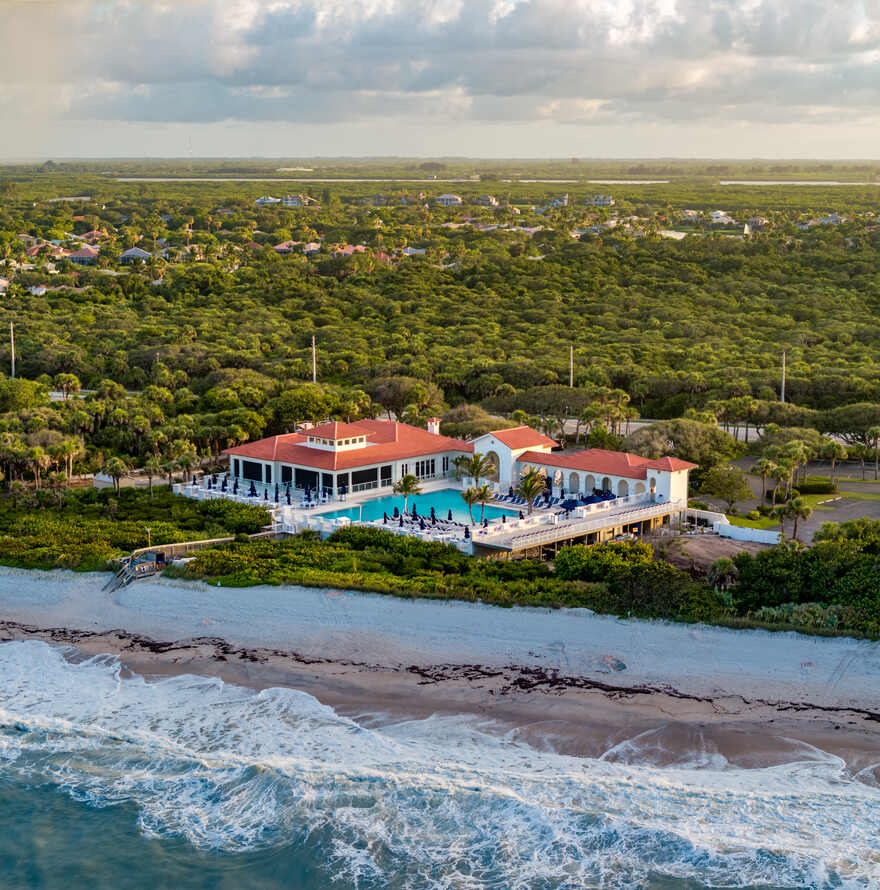 Aerial view of an oceanfront beach club on the Vero Beach barrier island at golden hour